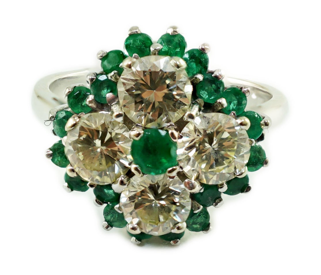 An 18ct white gold, emerald and diamond cluster set dress ring